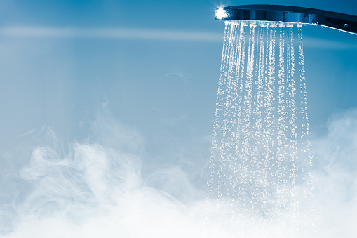 shower with flowing water and steam